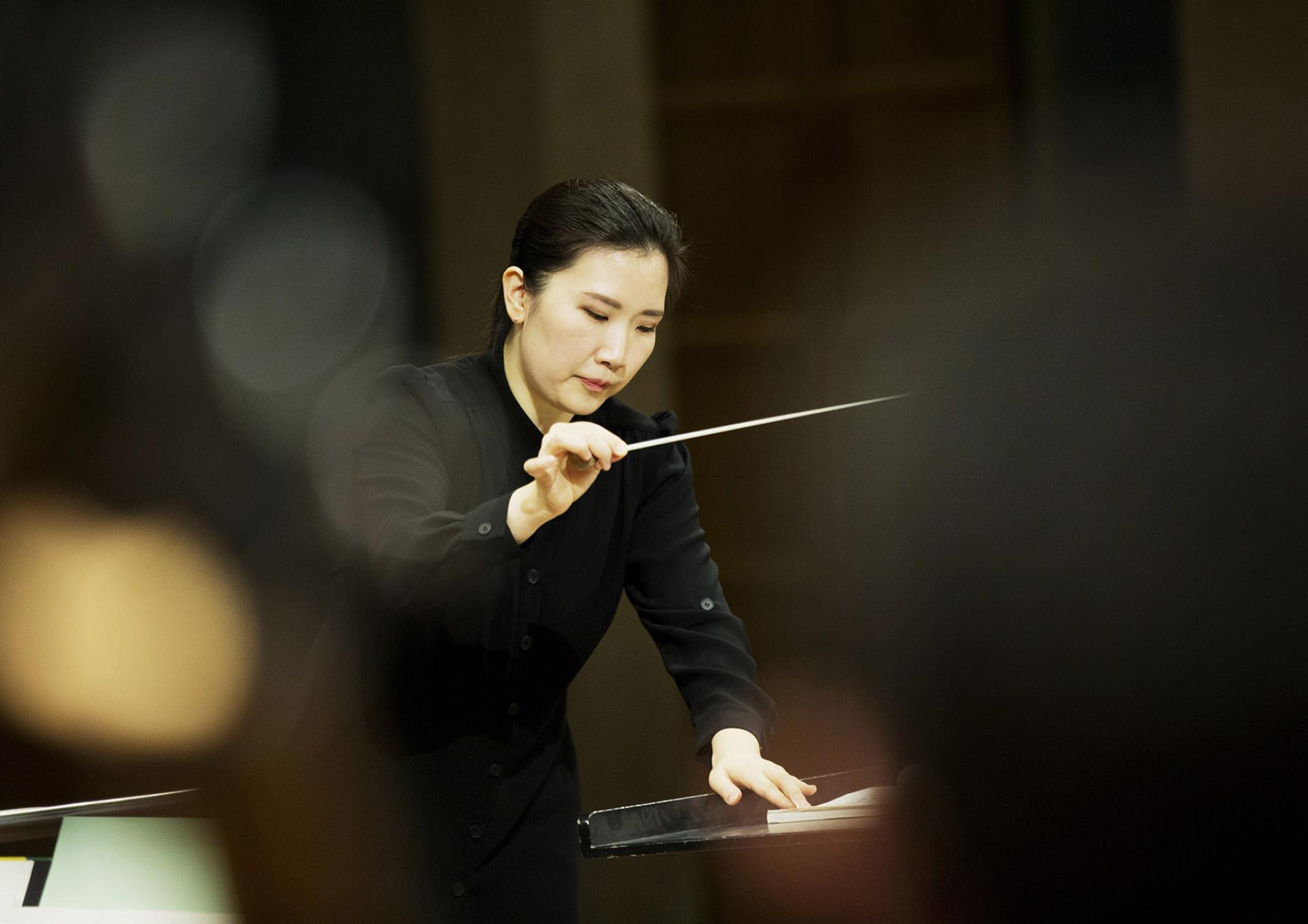 Eun Sun Kim, female conductor from South Korea, with baton
